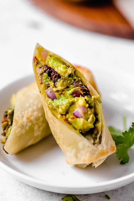 These Avocado Egg Rolls are inspired by the Cheesecake Factory egg rolls, only healthier because they are not fried. An easy air fryer recipe or bake them in the oven!