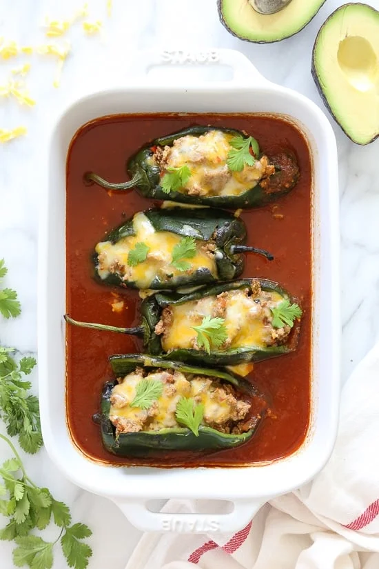 These baked Turkey Enchilada Stuffed Poblanos Rellenos are peppers stuffed with a flavorful ground turkey filling, topped with my homemade enchilada sauce and cheese. 