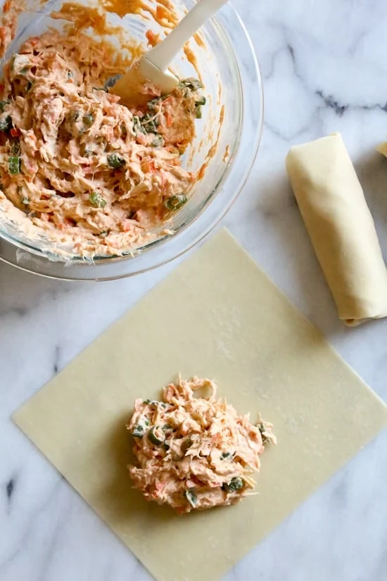 These Buffalo Chicken Egg Rolls, filled with shredded boneless chicken breast, hot sauce and blue cheese make the perfect appetizer! Bake them in the oven or air fryer!
