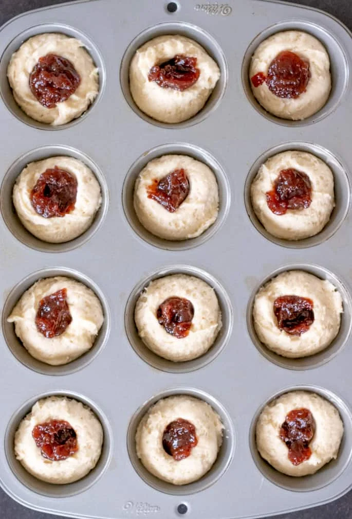 These extra tender gluten free donut muffins with jam filling taste like an old-fashioned cake donut, but they're baked easily in a muffin tin.