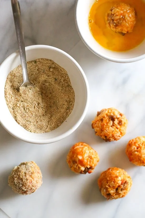 These Italian Cauliflower Rice Balls (Arancini) are made with cauliflower in place of rice! Lower in carbs and baked or made in the air fryer!