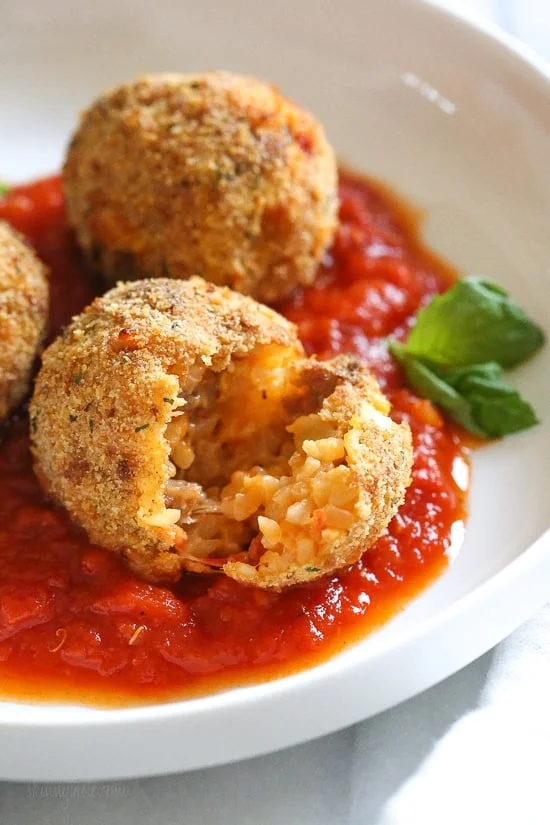 These Italian Cauliflower Rice Balls (Arancini) are made with cauliflower in place of rice! Lower in carbs and baked or made in the air fryer!