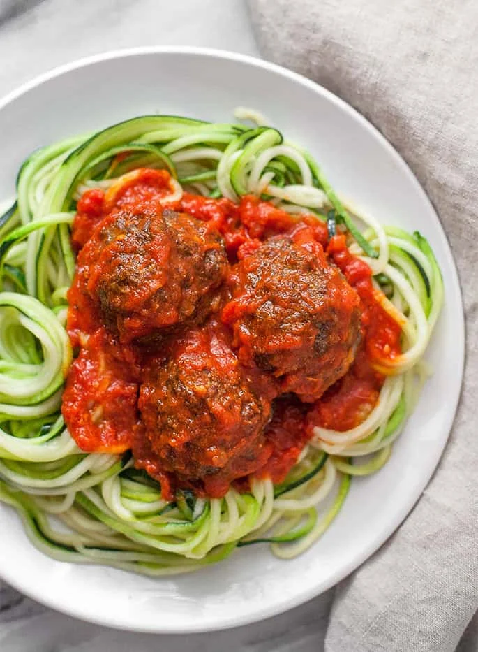These paleo meatballs are tender, flavorful, and super satisfying on top of a bed of spiralized zucchini noodles!
