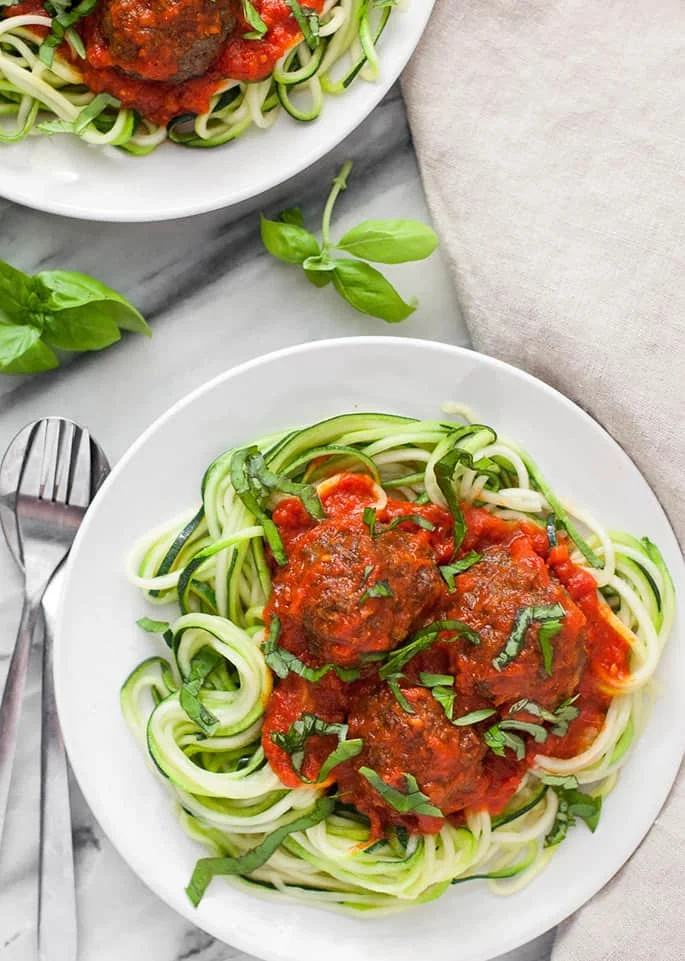 These paleo meatballs are tender, flavorful, and super satisfying on top of a bed of spiralized zucchini noodles!