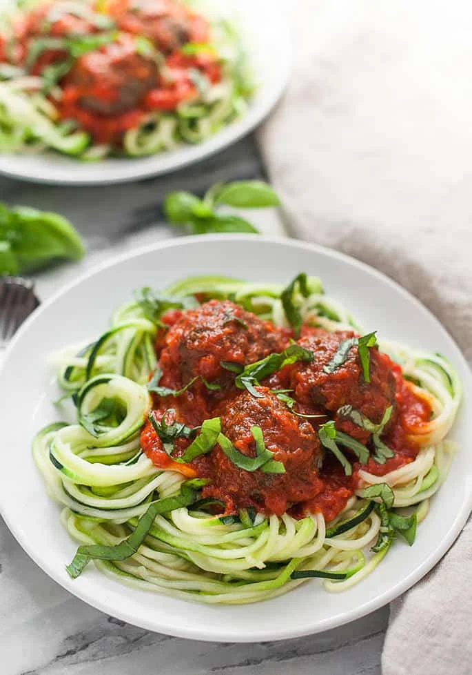 These paleo meatballs are tender, flavorful, and super satisfying on top of a bed of spiralized zucchini noodles!