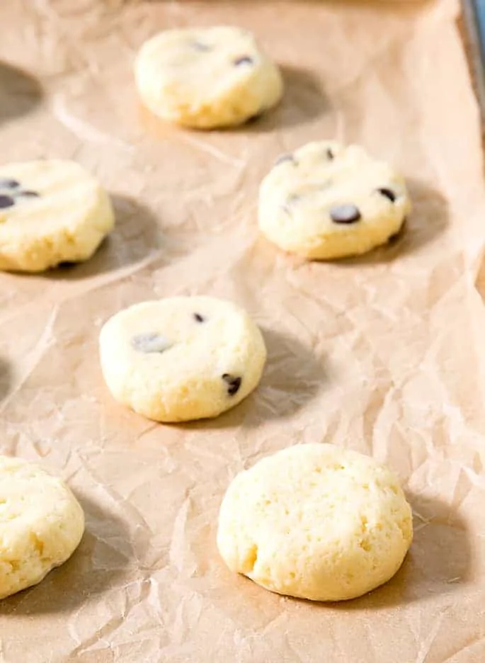These soft and chewy cheesecake cookies are made by dressing up a vanilla cake mix with cream cheese and eggs. The chocolate chips are optional, but highly recommended!