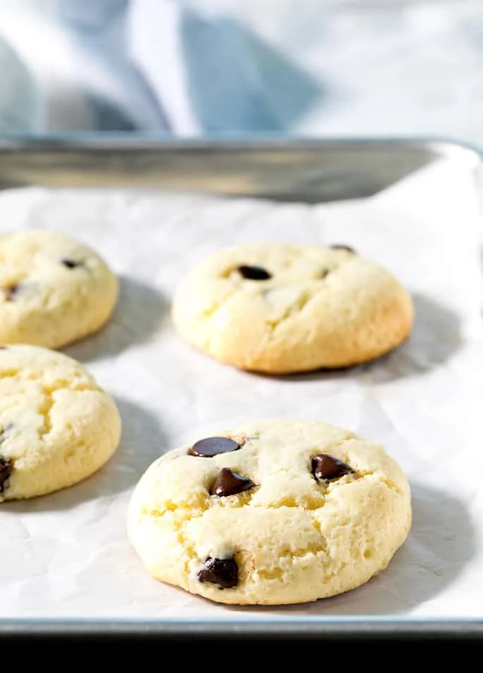 These soft and chewy cheesecake cookies are made by dressing up a vanilla cake mix with cream cheese and eggs. The chocolate chips are optional, but highly recommended!
