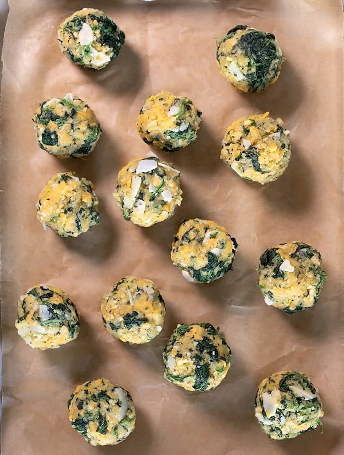 These spinach balls are a simple old-fashioned appetizer easily made gluten free with ordinary pantry ingredients. Little bites of cheesy good nostalgia.