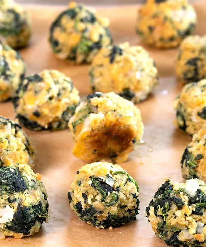 These spinach balls are a simple old-fashioned appetizer easily made gluten free with ordinary pantry ingredients. Little bites of cheesy good nostalgia.