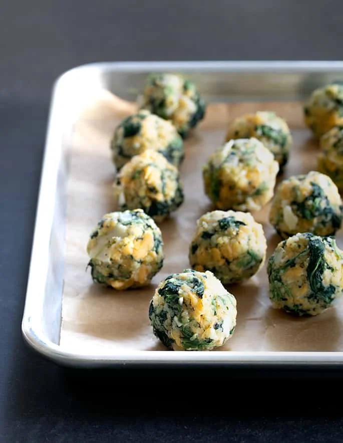 These spinach balls are a simple old-fashioned appetizer easily made gluten free with ordinary pantry ingredients. Little bites of cheesy good nostalgia.