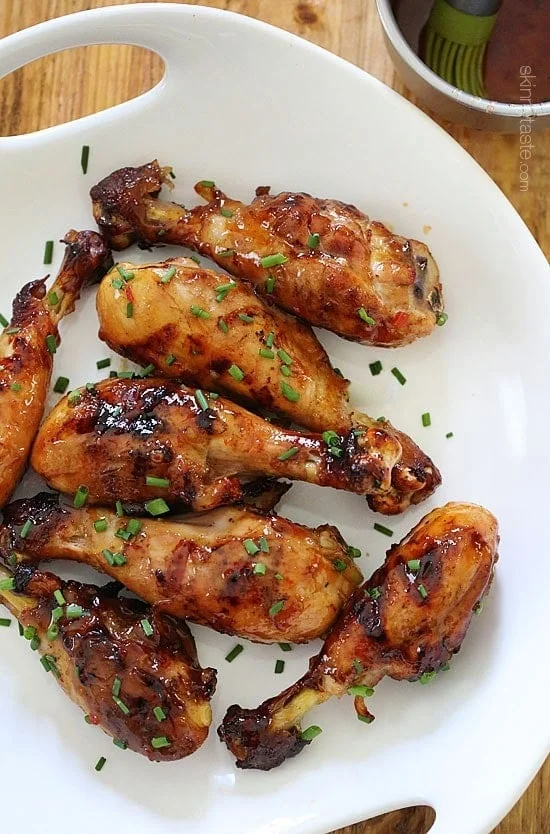 These sweet 'n spicy Asian glazed grilled drumsticks are finger licking good! An inexpensive, weeknight dish you'll want to make all summer long!