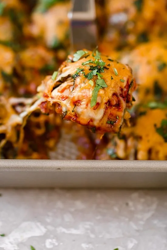 These Zucchini Chicken Enchilada Roll Ups are filled seasoned shredded chicken, topped with enchilada sauce and cheese. Delicious, and perfect for Keto, gluten-free or low-carb diets.