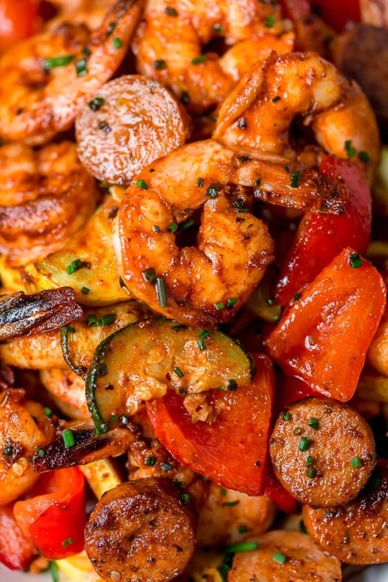 This fast and easy Air Fryer Cajun Shrimp recipe is a meal-in-one, made with shrimp, sausage, and lots of colorful vegetables such as zucchini, yellow squash and bell peppers.