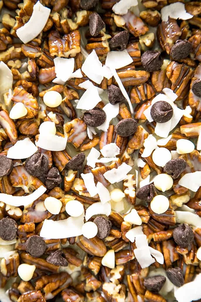 This recipe for 7 Layer Bars is endlessly customizable, made easily with or without coconut, gluten free graham cracker crumbs, and even easily made dairy free!