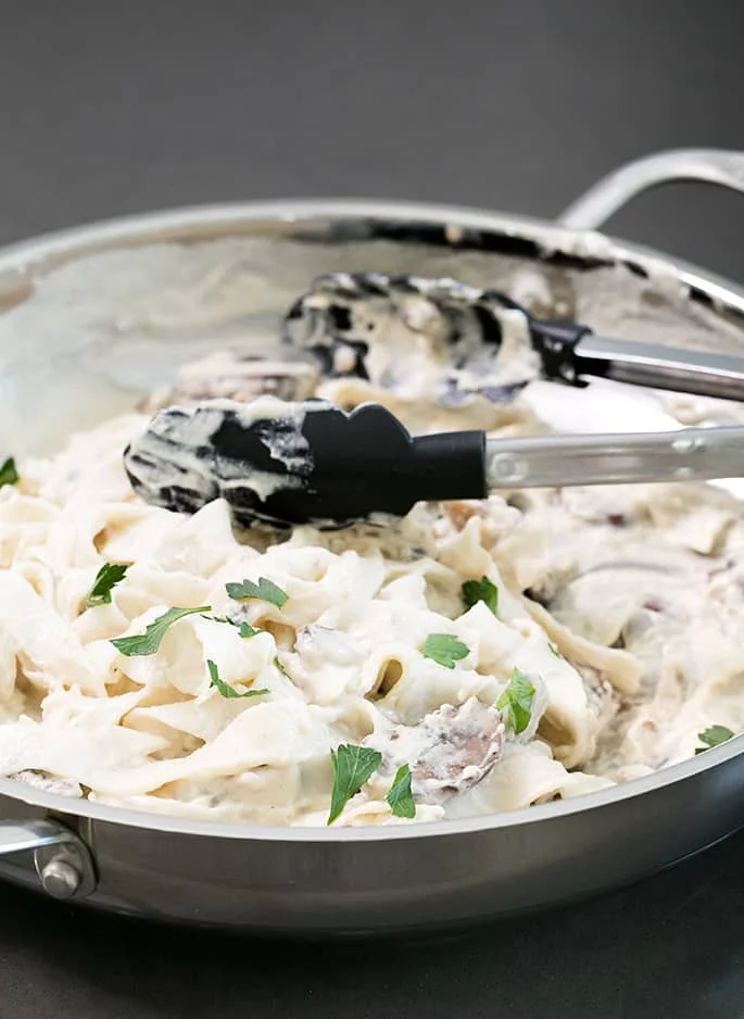 This rich, creamy vegan alfredo sauce is made with cashews and coconut milk, and no nutritional yeast. It even reheats beautifully.