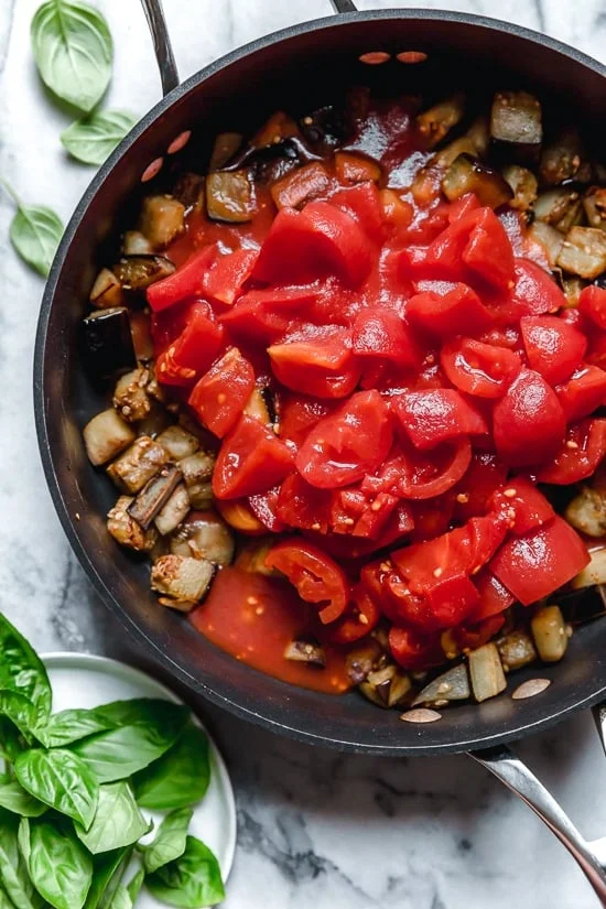 This simple Eggplant and Tomato Sauce is delicious, made with diced eggplant stewed in tomatoes and garlic. I love it served over pasta but it's also great as a side dish on it's own.