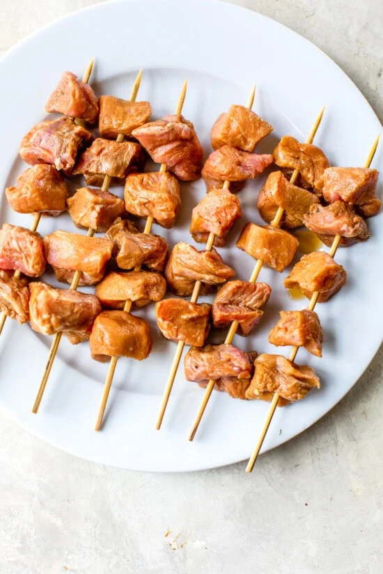 Thread the pork onto the skewers.