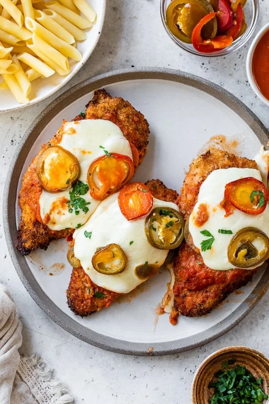 Three pieces of vodka chicken parm on a plate