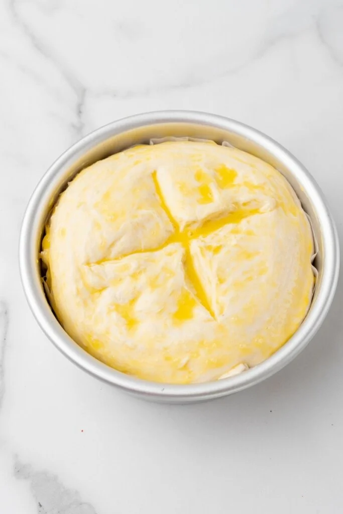 Top of homemade bread brushed with egg before baking.