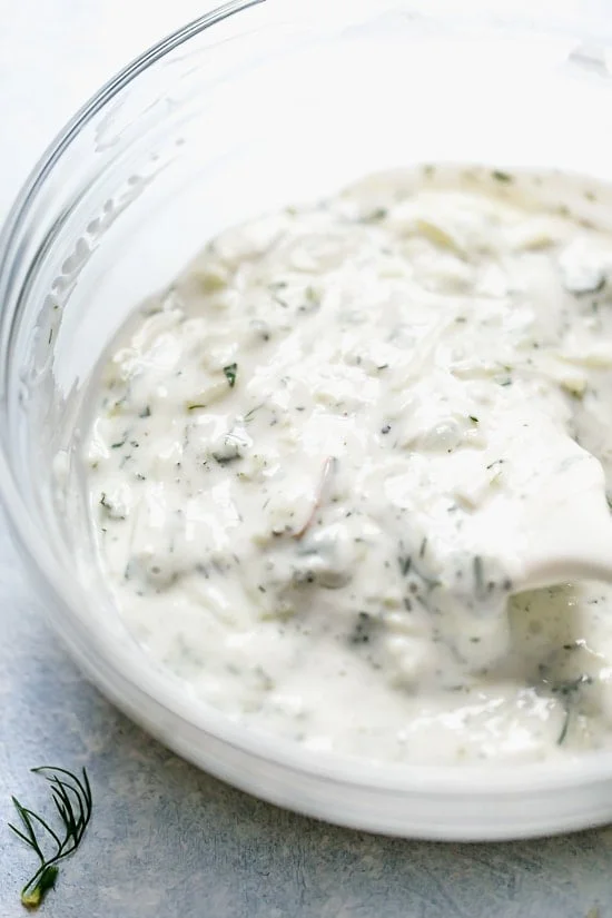 Tzatziki Fish Tacos have a Greek twist! Made with breaded white fish filet topped with mint tzatziki sauce.