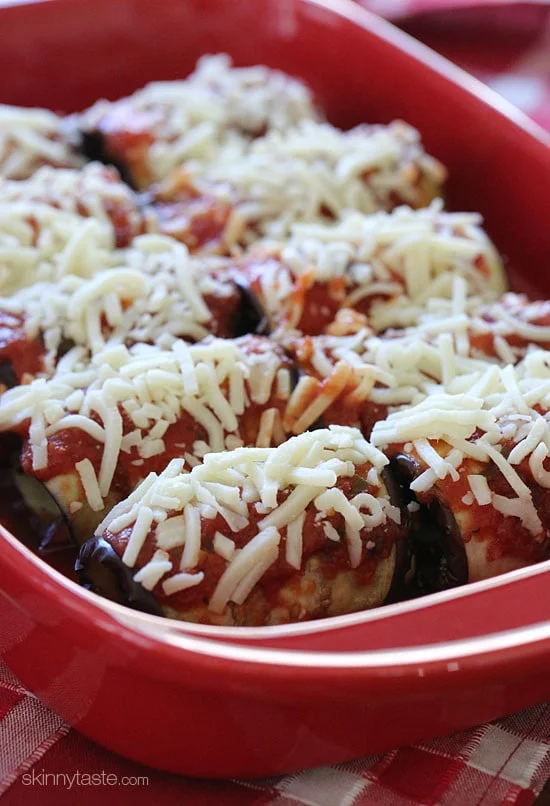 Unbaked eggplant rollatini in a baking dish.