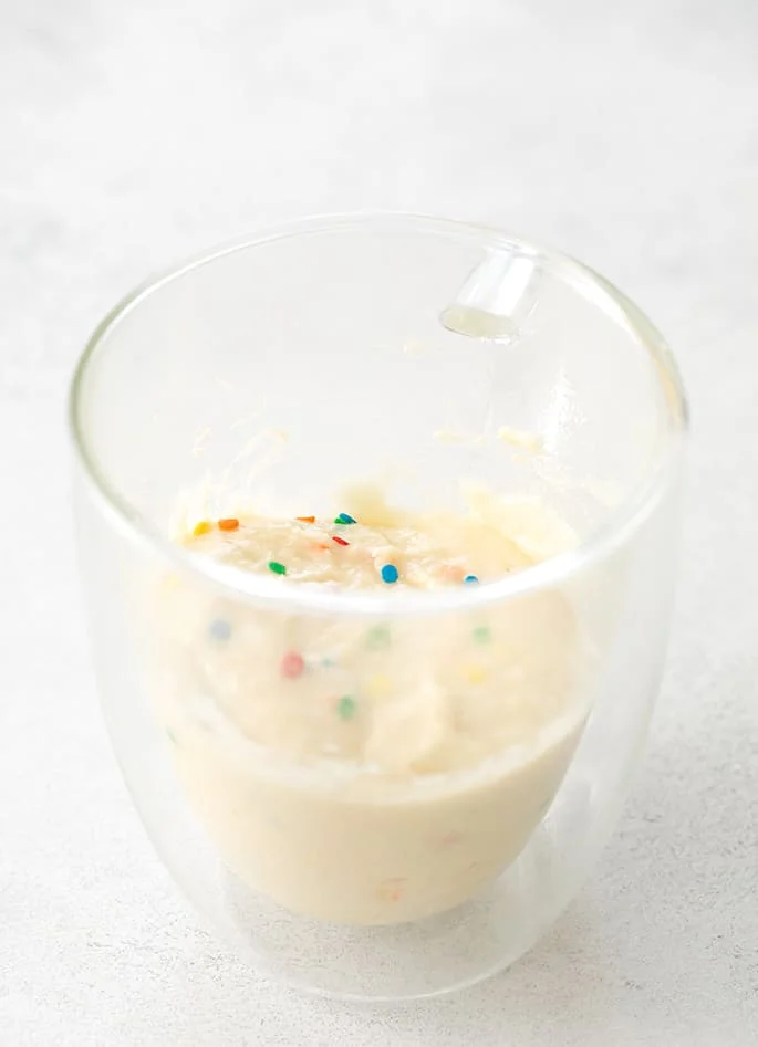 Vanilla mug cake batter raw in mug image from side