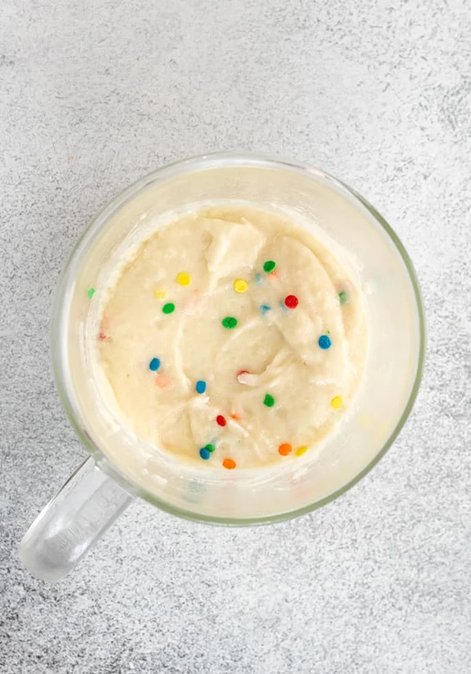 Vanilla mug cake raw batter in mug overhead image