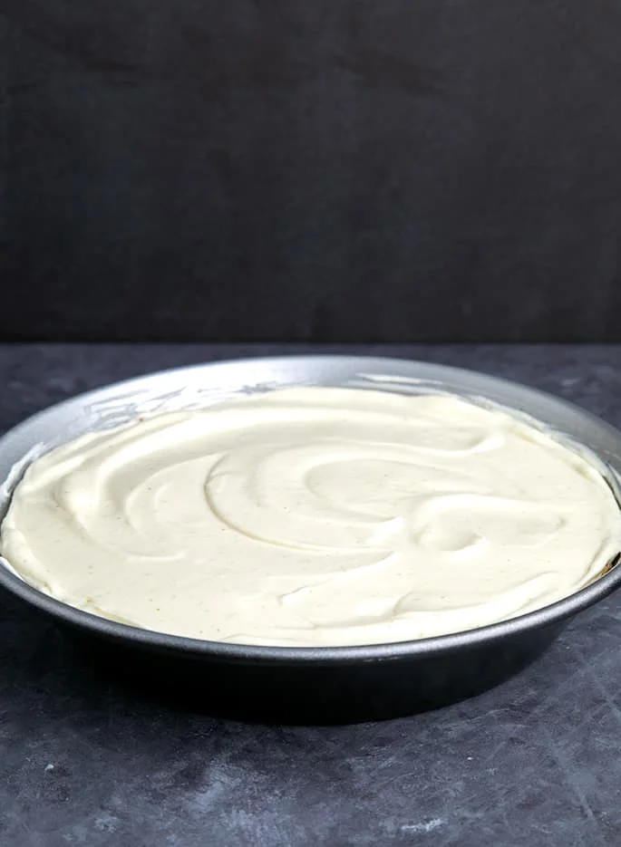 Very light green pie filling in round metal pie pan
