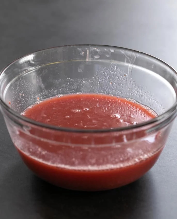 Warm strawberry homemade jello mixture in a bowl