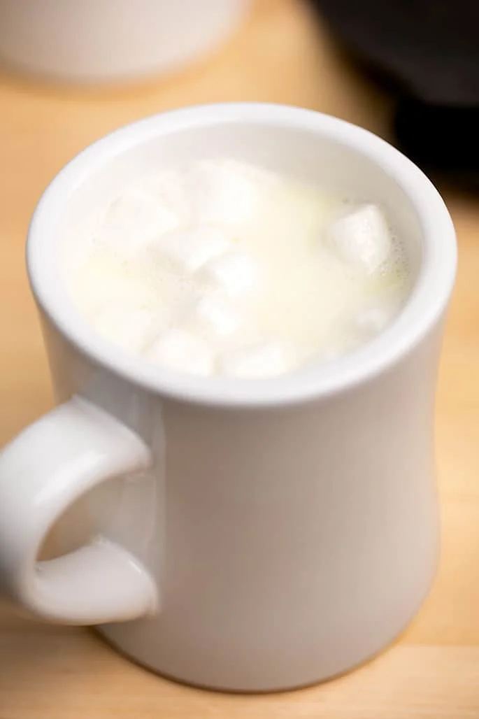 White hot chocolate in white mug with 10 mini marshmallows