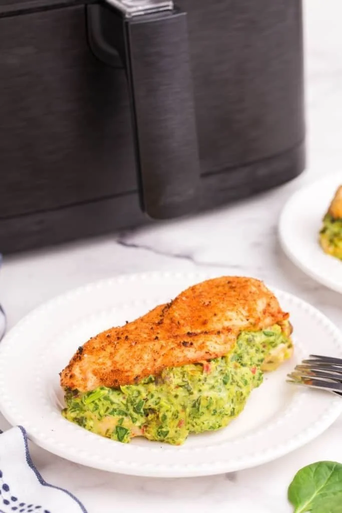 white plate with air fryer stuffed chicken breast