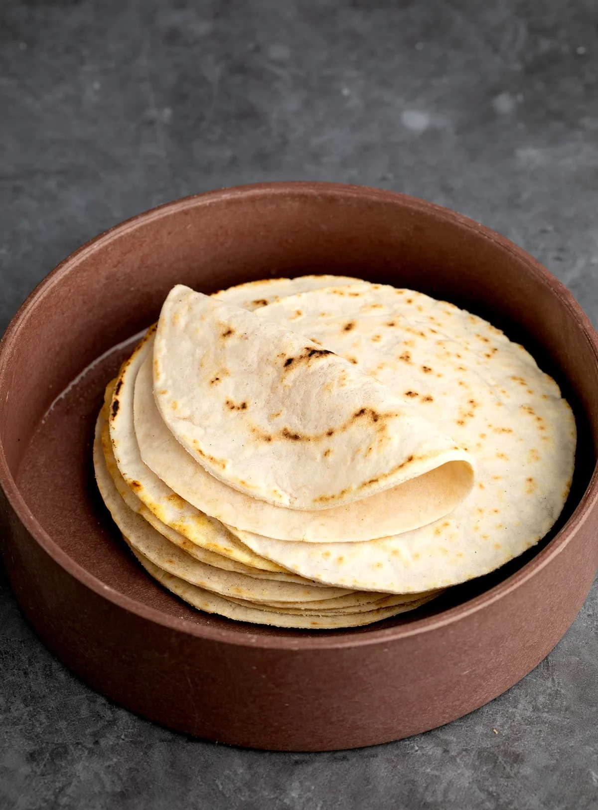Wider shot of cassava flour tortillas stack with one folded on top