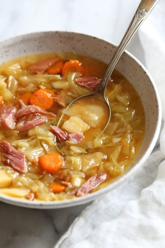 Bowl of ham bone soup with potatoes and cabbage