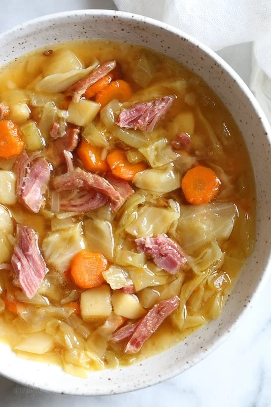 Bowl of leftover ham bone soup with potatoes and cabbage
