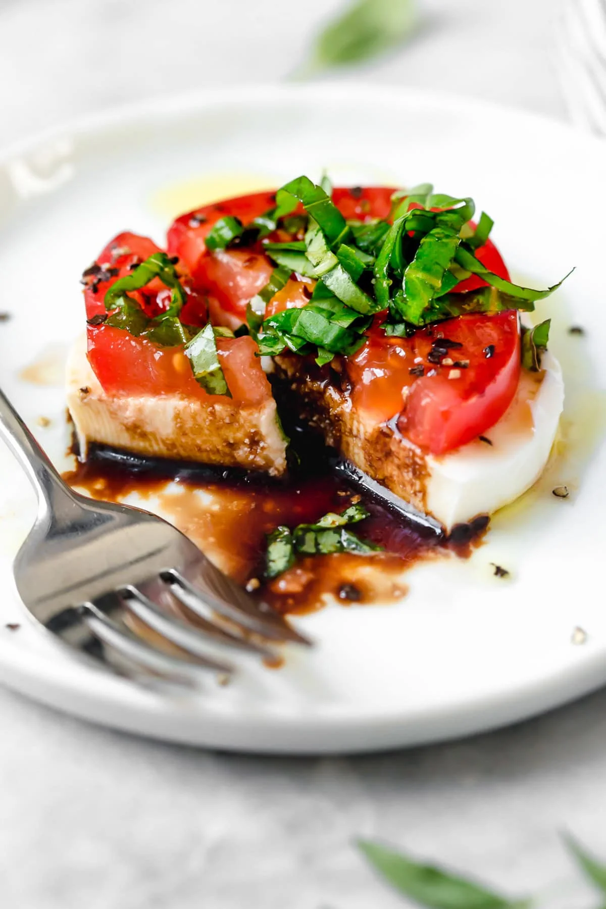 Caprese salad on plate with fork