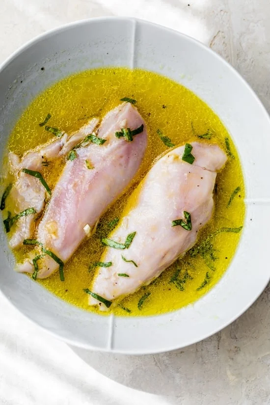 Chicken marinating in the citrus dressing for a summer chicken salad.