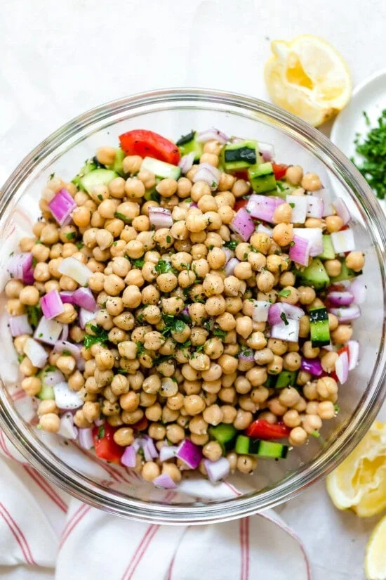 chickpeas in a bowl with tomatoes and cucumbers