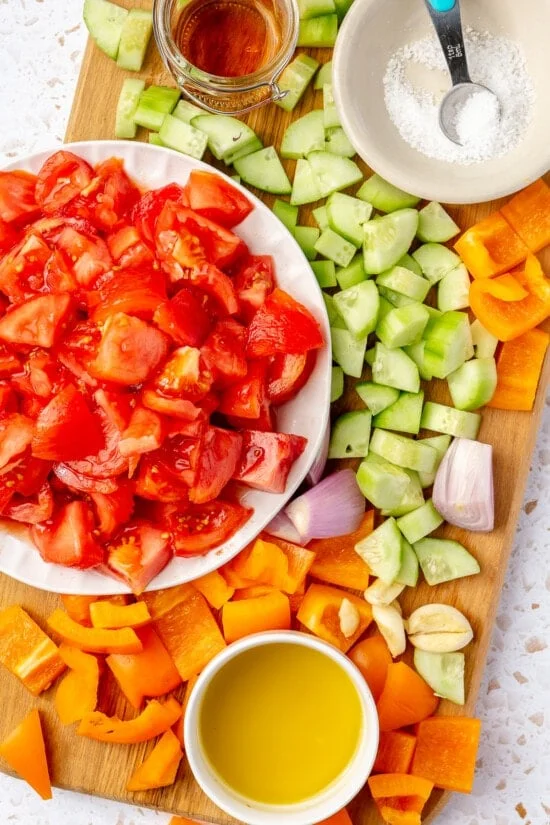 Chopped vegetables for gazpacho on a cutting board.