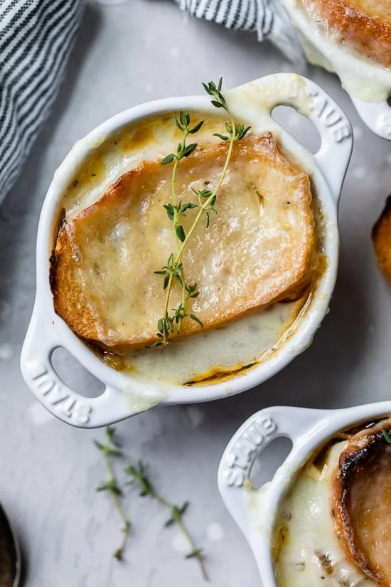 Overhead view of French onion soup in ramekins.