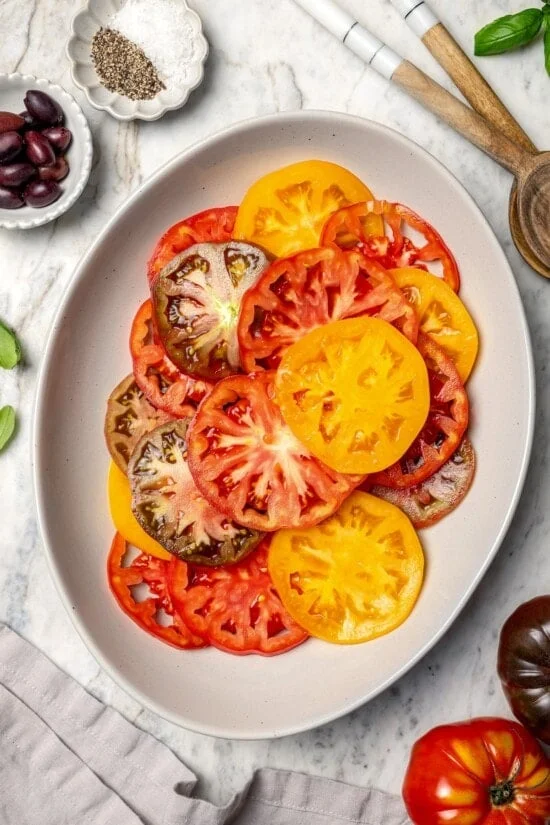 Overhead view of sliced heirloom tomatoes on platter