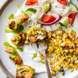 peruvian chicken on plate with rice and corn