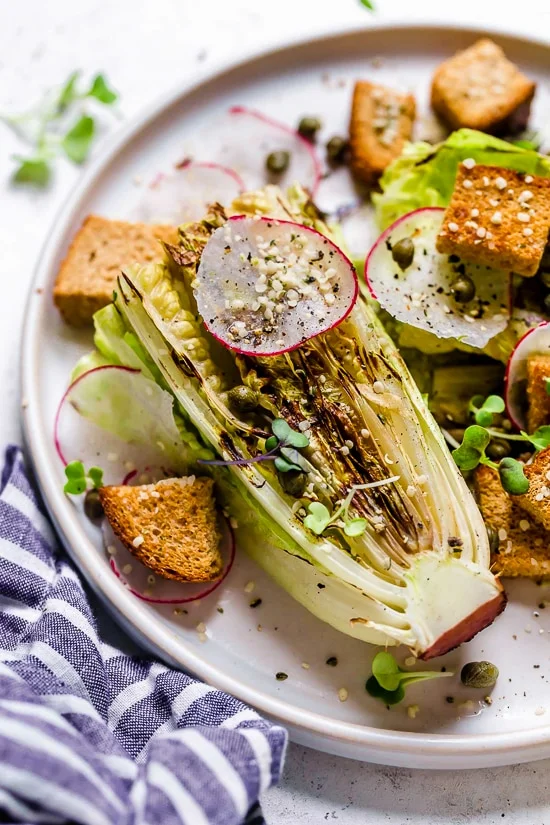 Plate of vegan Caesar salad with grilled romaine.