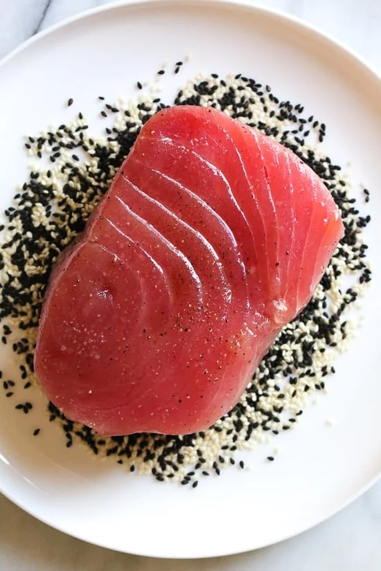 Sesame Crusted Tuna Steak on Arugula drizzled with a balsamic soy-ginger vinaigrette – yum!
