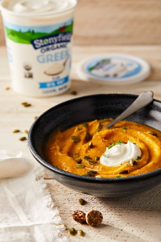 This healthy, creamy Pumpkin Ginger Soup is the perfect cozy, fall soup made creamy without adding any cream. Instead, the vegetables and Greek yogurt thicken it!