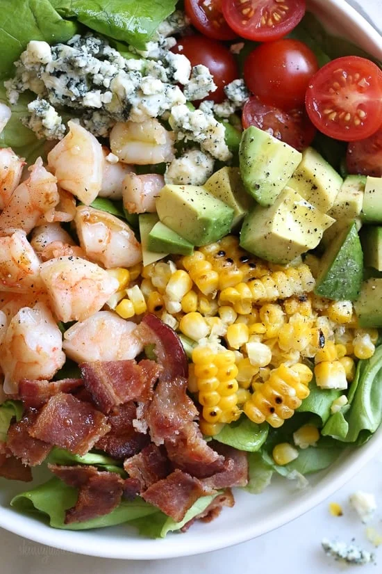 This hearty Chopped Salad with Shrimp, Avocado, Blue Cheese and Bacon is simple and satisfying. Great for lunch or dinner!